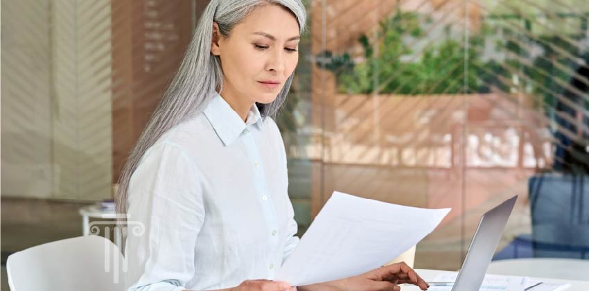 Woman reviewing legal documents, such as, will, power of attorney, etc.